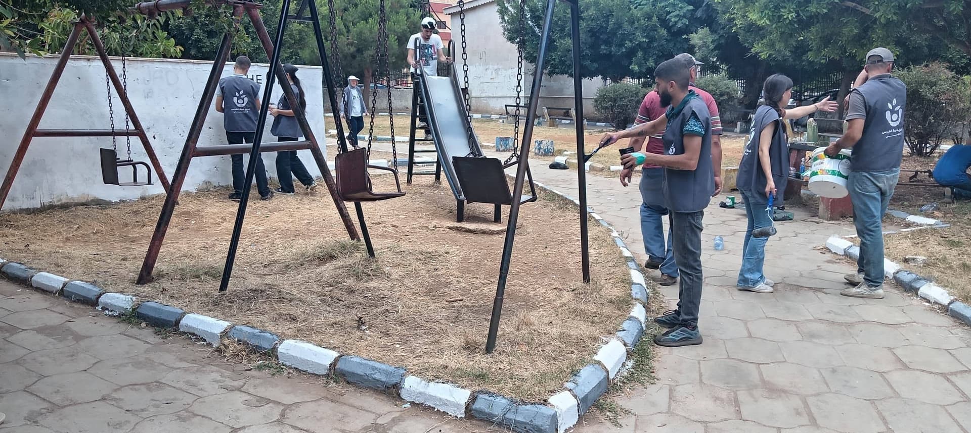 المتطوعون يقومون بطلاء المراجيح
